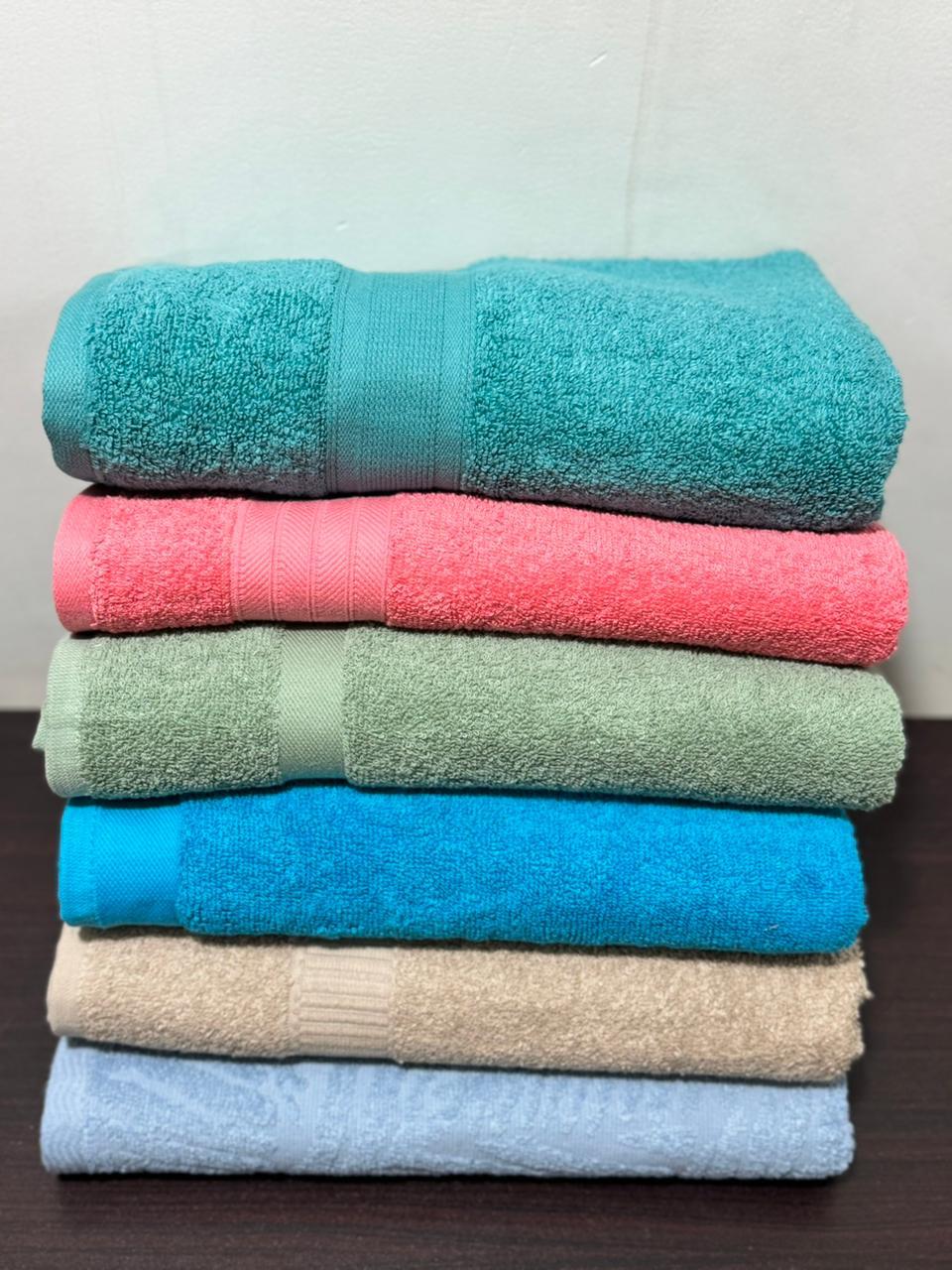Real factory photo: folded stack of bulk bath towels